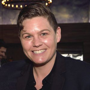 An image of a person named Lynn Faria with short brown hair, white skin, wearing a black shirt and smiling at the camera.