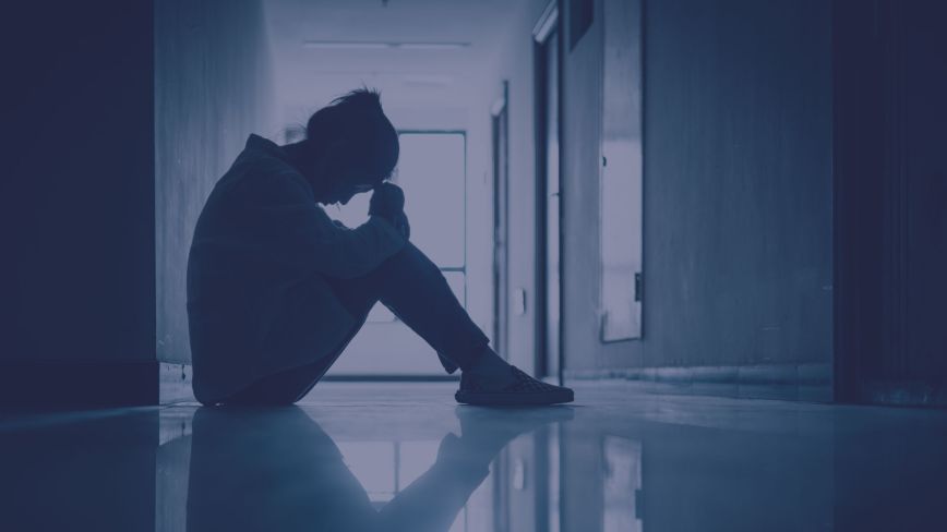 A person sitting in a hallway