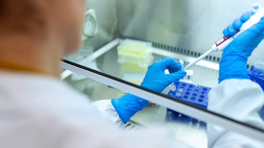Scientist in lab using a syringe