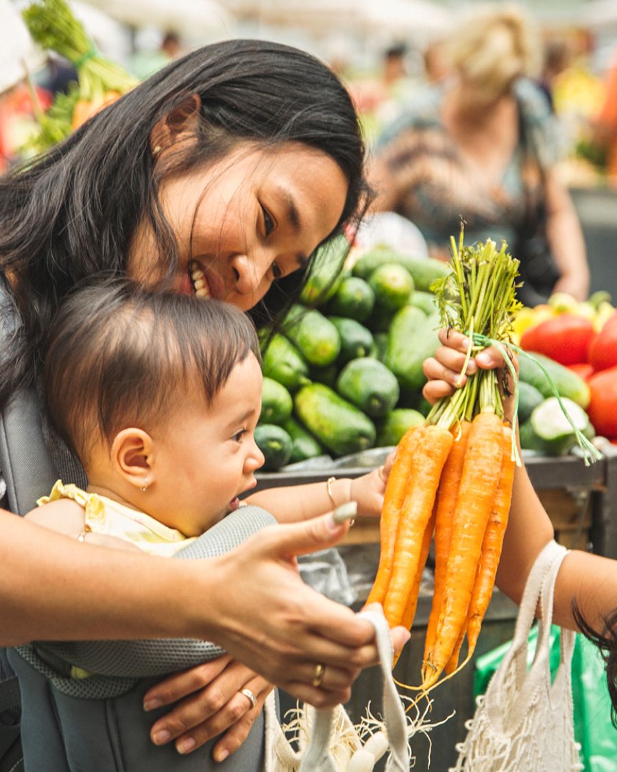 A mother and two young children in a grocery store.